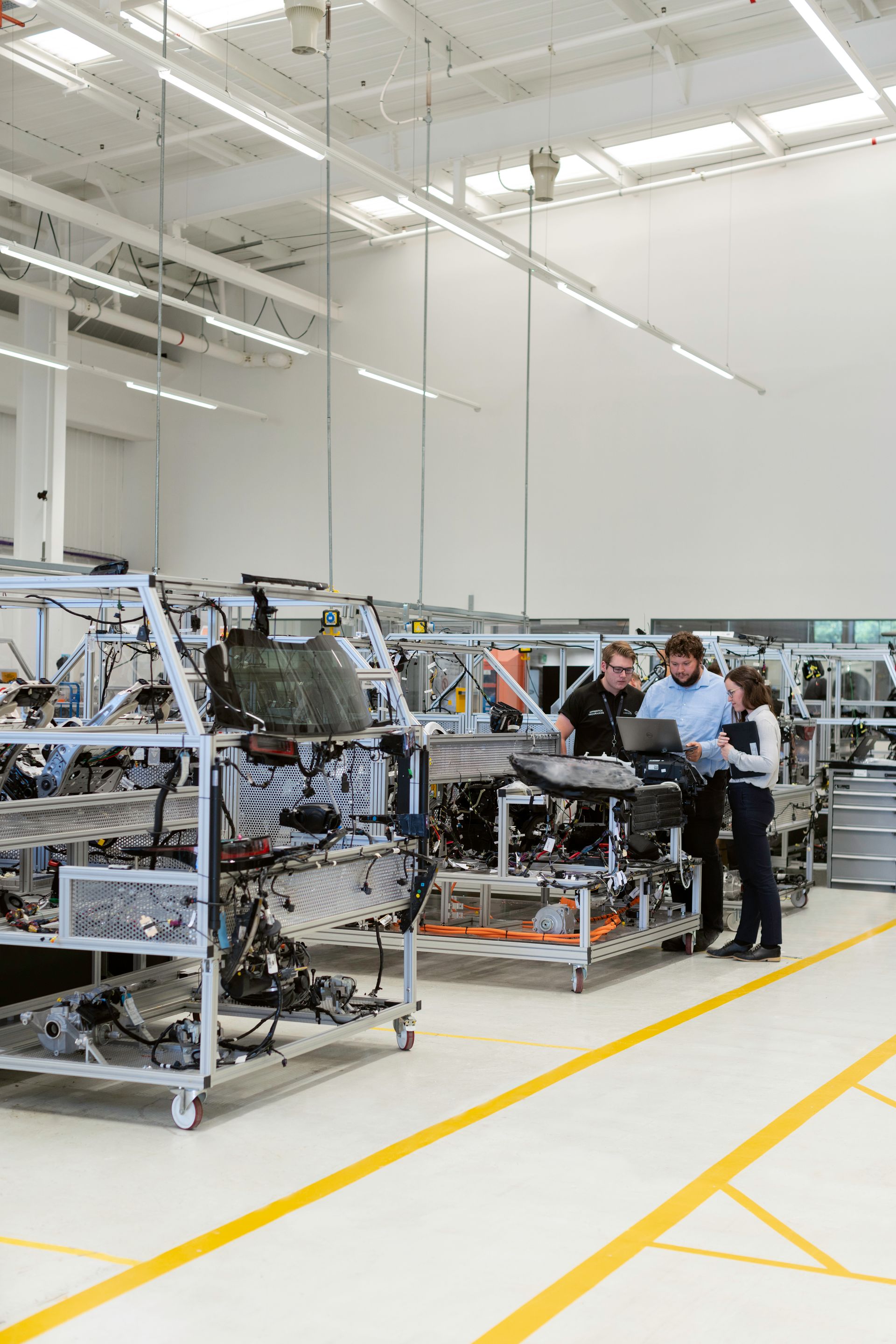 Engineers reviewing a vehicle system in a workshop