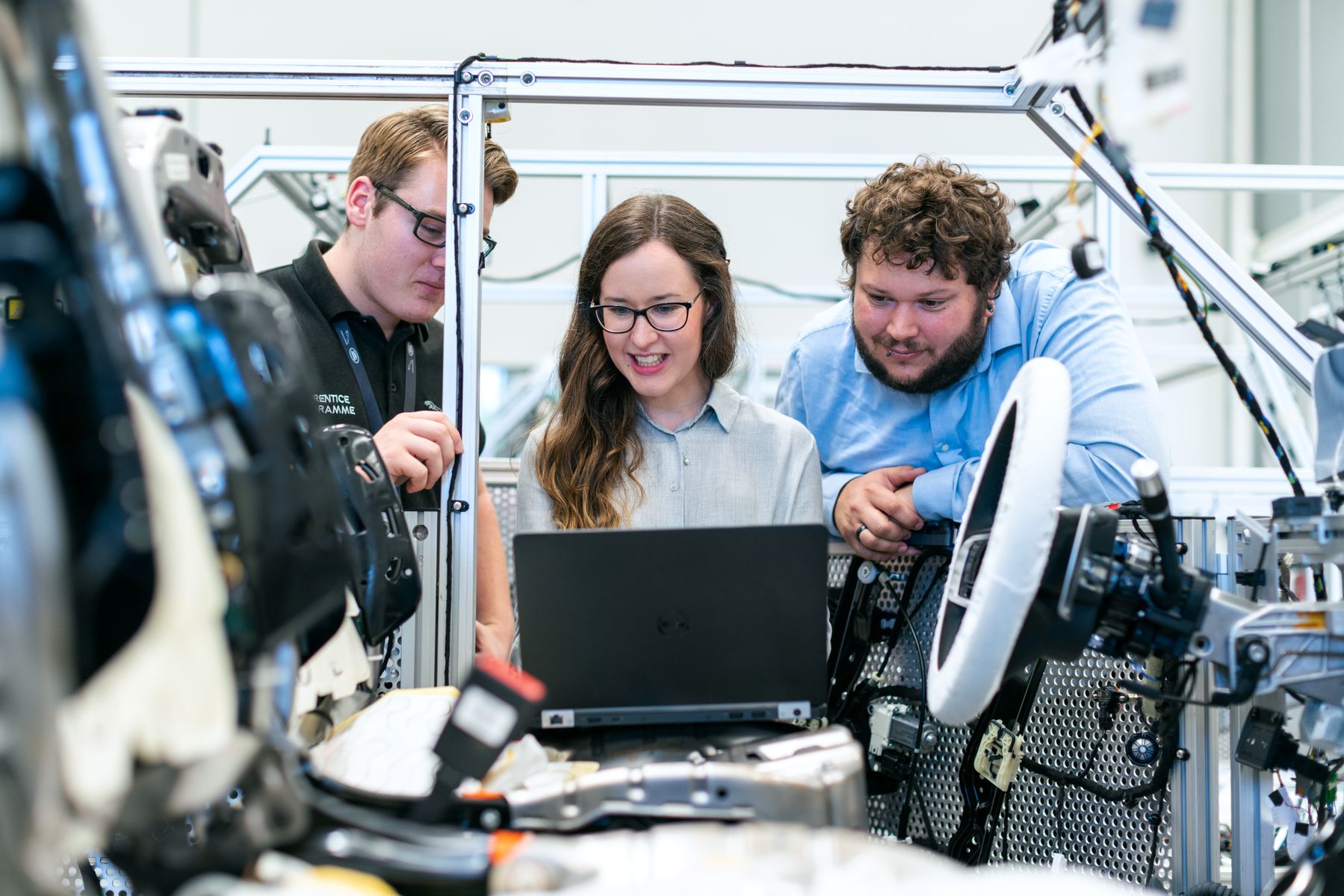 Automotive engineers collaborating in a workshop