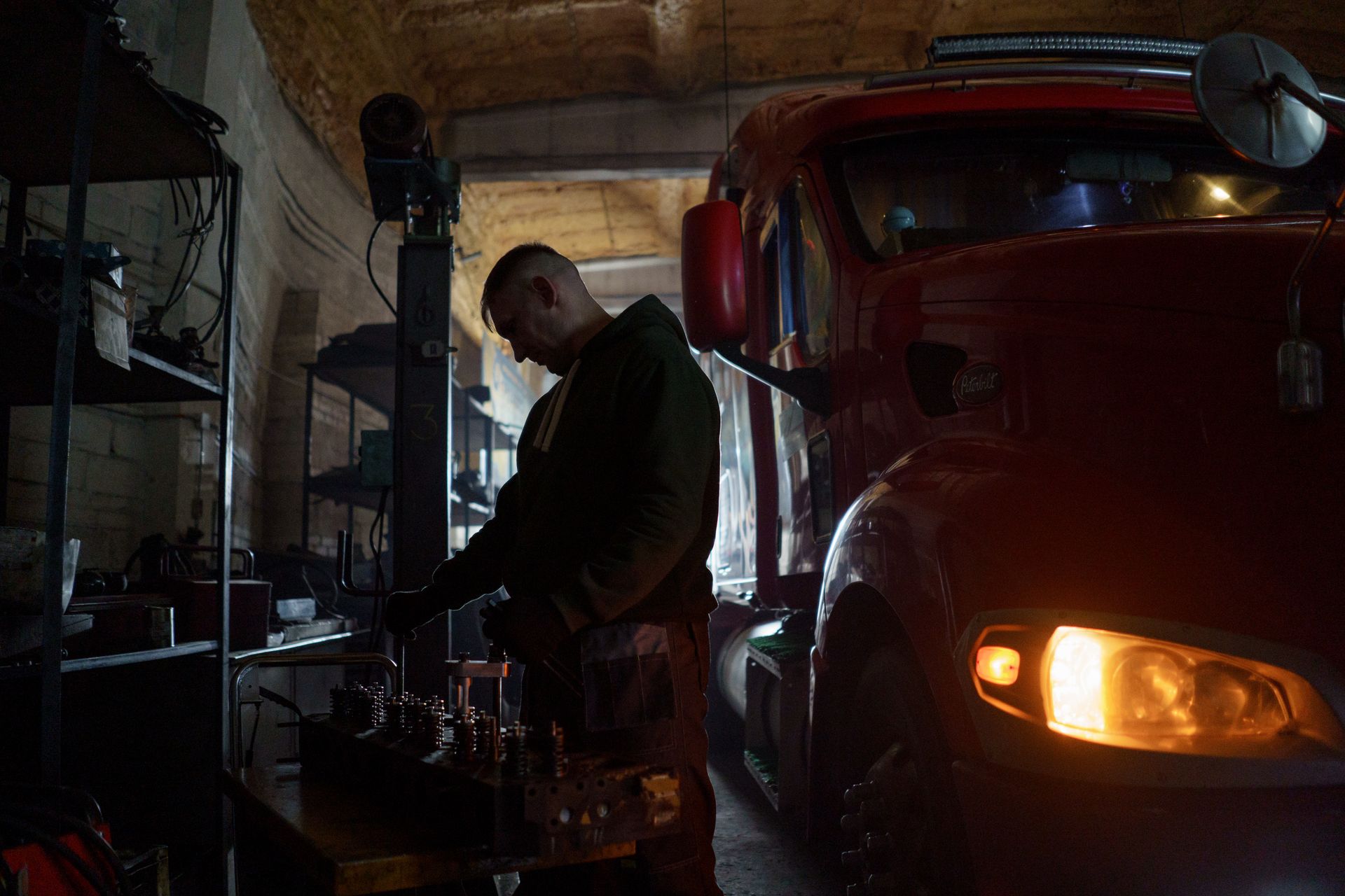 Technician working beside a commercial truck