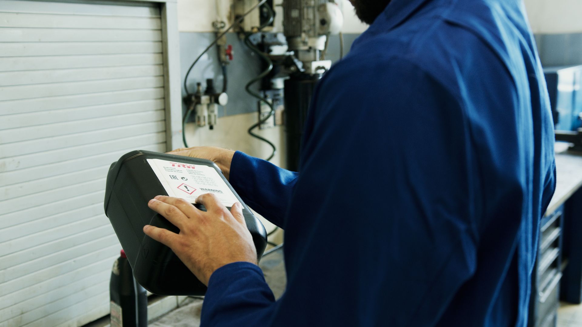 Automotive technician carrying out a workshop inspection
